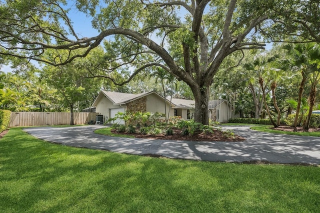 7935 SW 155th St, Palmetto Bay, FL 33157 - view of front facade with driveway, stucco siding, and an attached garage