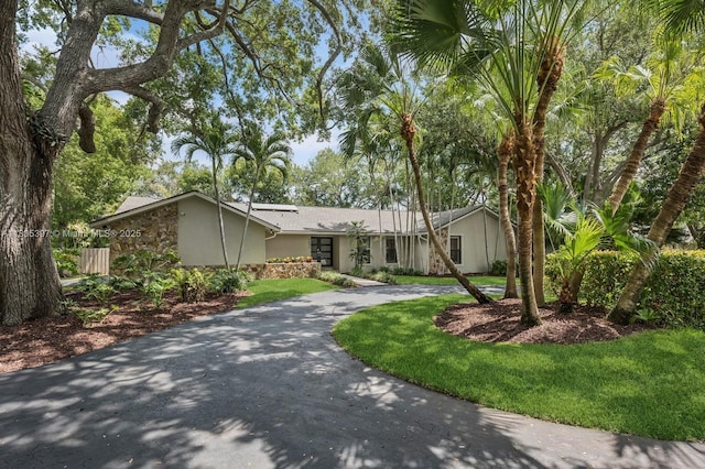 7935 SW 155th St, Palmetto Bay, FL 33157 - mid-century home with curved driveway, stucco siding, and stone siding