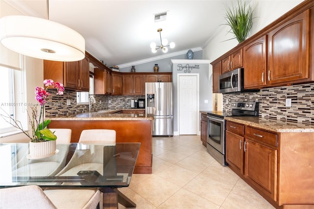 921 SW 176th Ave, Pembroke Pines, FL 33029 - kitchen with stainless steel appliances, crown molding, lofted ceiling, backsplash, and a chandelier
