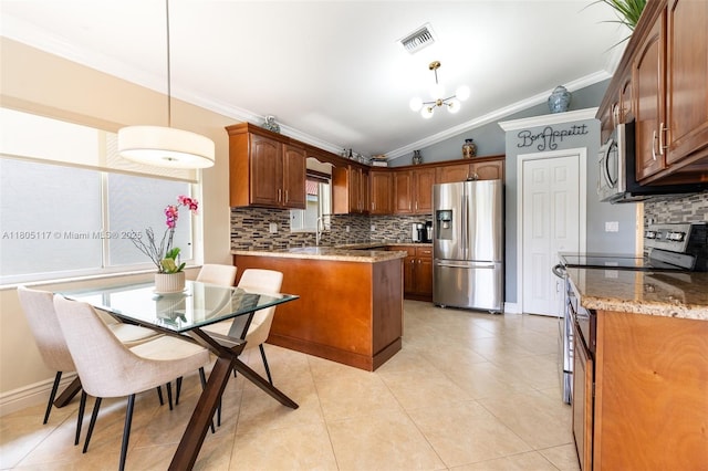 921 SW 176th Ave, Pembroke Pines, FL 33029 - kitchen with appliances with stainless steel finishes, ornamental molding, tasteful backsplash, a peninsula, and vaulted ceiling