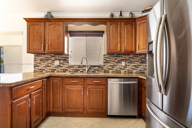 921 SW 176th Ave, Pembroke Pines, FL 33029 - kitchen featuring appliances with stainless steel finishes, a sink, tasteful backsplash, light tile patterned floors, and brown cabinetry