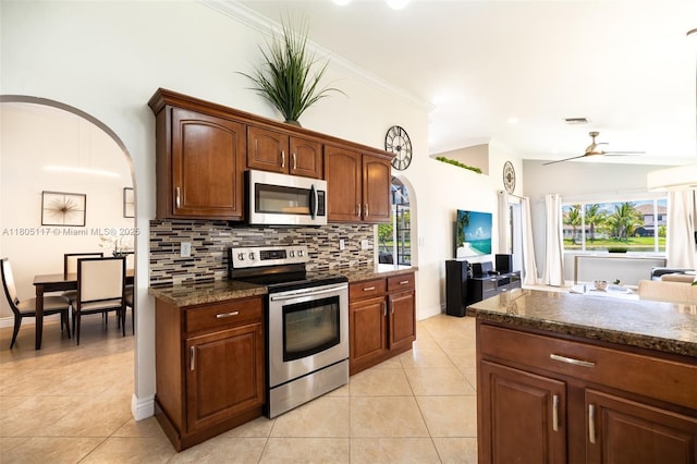 921 SW 176th Ave, Pembroke Pines, FL 33029 - kitchen with appliances with stainless steel finishes, light tile patterned floors, a ceiling fan, decorative backsplash, and crown molding