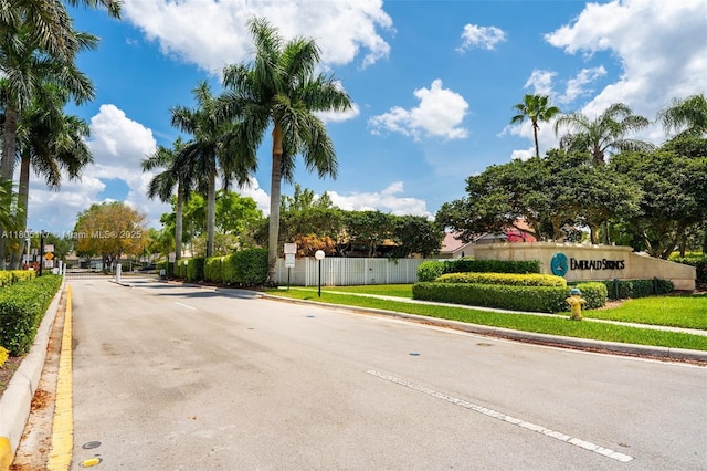 921 SW 176th Ave, Pembroke Pines, FL 33029 - view of asphalt street featuring curbs, sidewalks, a gated entry, and traffic signs