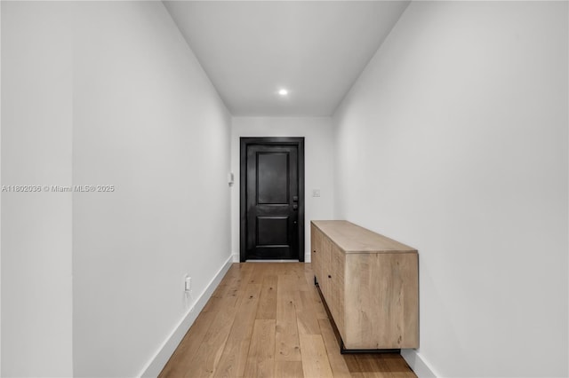 doorway featuring light wood-type flooring, baseboards, and recessed lighting