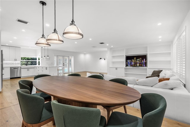 dining space featuring light wood-type flooring and recessed lighting