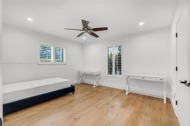unfurnished room with plenty of natural light, ceiling fan, light wood-style flooring, recessed lighting, and baseboards