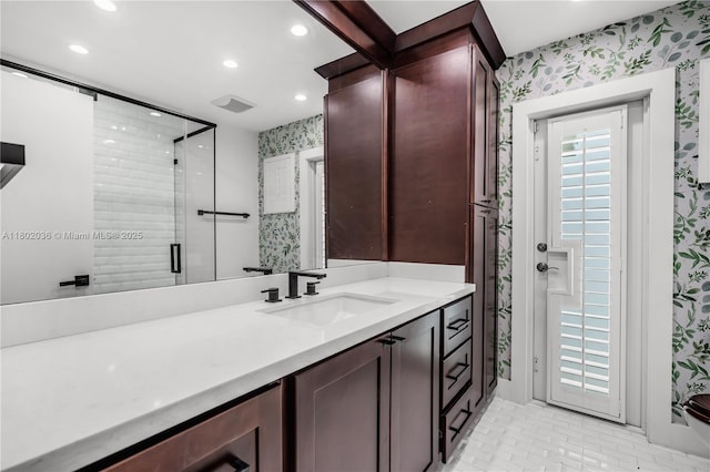 bathroom with wallpapered walls, recessed lighting, a shower stall, and vanity