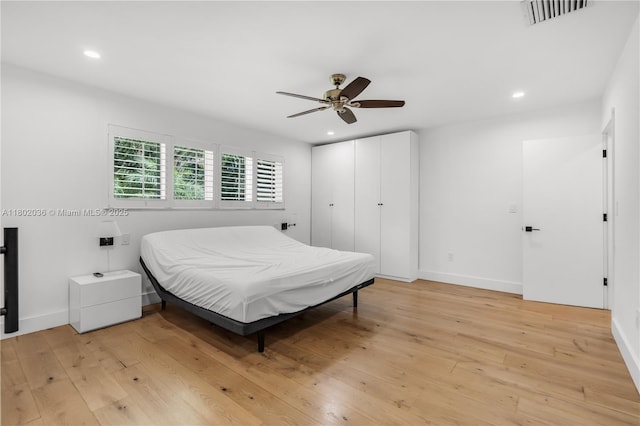 bedroom with light wood-type flooring, recessed lighting, baseboards, and ceiling fan