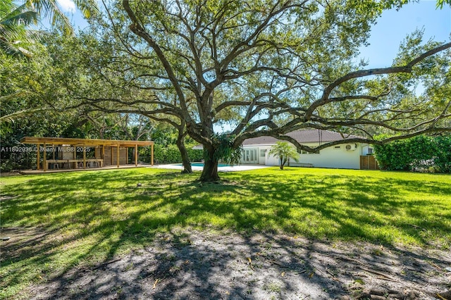 view of grassy yard featuring an outdoor pool