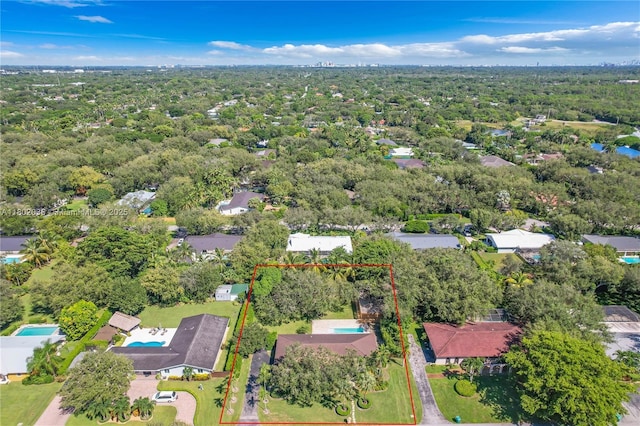 aerial view of property and surrounding area featuring property parcel outlined