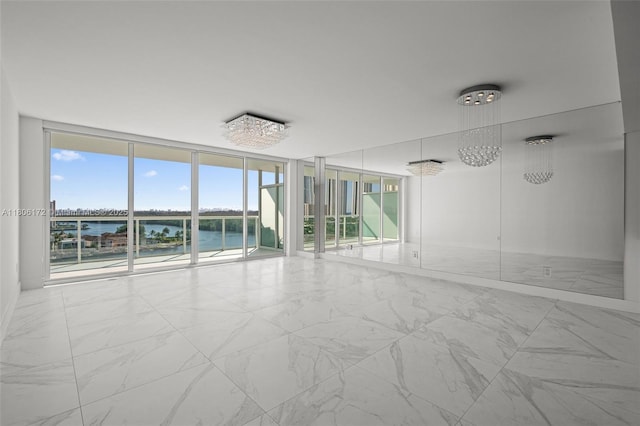400 Sunny Isles Blvd Unit 1005, Sunny Isles Beach, FL 33160 - spare room with expansive windows, marble finish flooring, a water view, and healthy amount of natural light