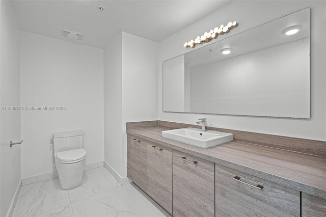 400 Sunny Isles Blvd Unit 1005, Sunny Isles Beach, FL 33160 - bathroom featuring marble look tile flooring, baseboards, toilet, and vanity