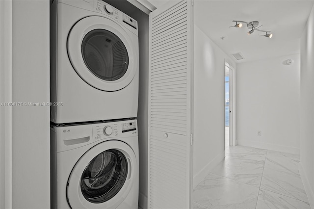 400 Sunny Isles Blvd Unit 1005, Sunny Isles Beach, FL 33160 - clothes washing area featuring stacked washer / dryer, marble finish floors, and baseboards