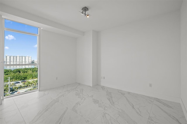 400 Sunny Isles Blvd Unit 1005, Sunny Isles Beach, FL 33160 - spare room with marble finish flooring, a view of city, and baseboards