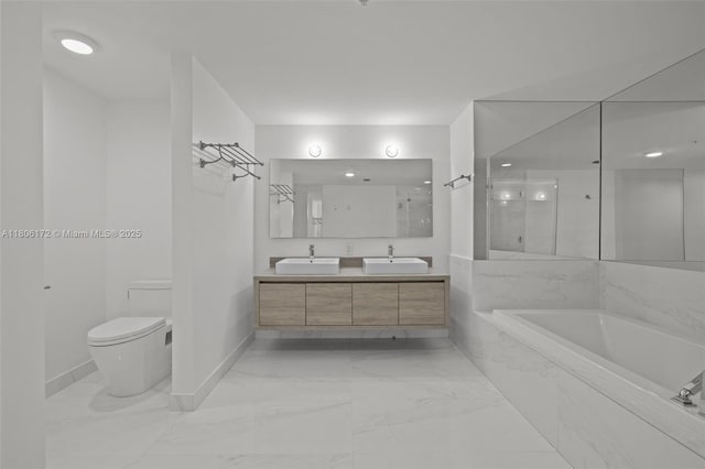 400 Sunny Isles Blvd Unit 1005, Sunny Isles Beach, FL 33160 - bathroom featuring marble finish flooring, baseboards, a bath, toilet, and double vanity