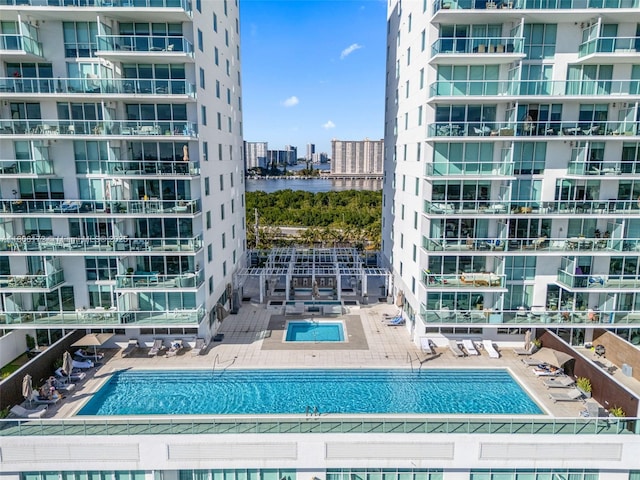 400 Sunny Isles Blvd Unit 1005, Sunny Isles Beach, FL 33160 - community pool featuring a water view and a patio area
