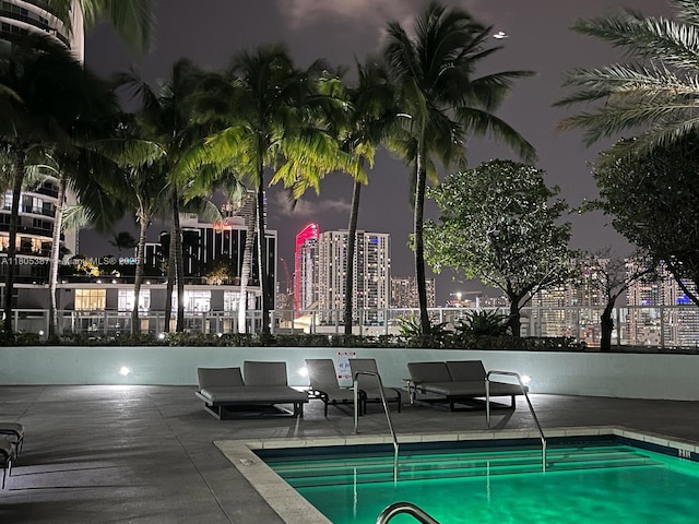 1900 N Bayshore Dr Unit 2804, Miami, FL 33132 - pool at twilight with a community pool, a view of city lights, and a patio area