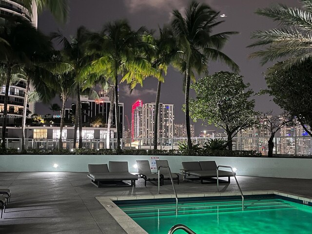 1900 N Bayshore Dr Unit 2804, Miami, FL 33132 - pool at twilight with a community pool, a view of city lights, and a patio area