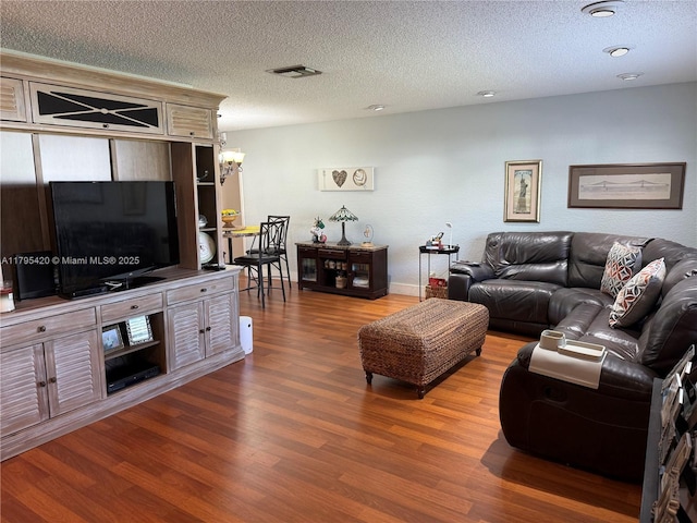 1250 NW 85th Ave, Plantation, FL 33322 - living room with wood finished floors, a textured ceiling, a chandelier, and baseboards