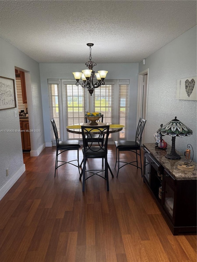 1250 NW 85th Ave, Plantation, FL 33322 - dining area featuring a textured ceiling, a chandelier, a textured wall, dark wood-style flooring, and baseboards