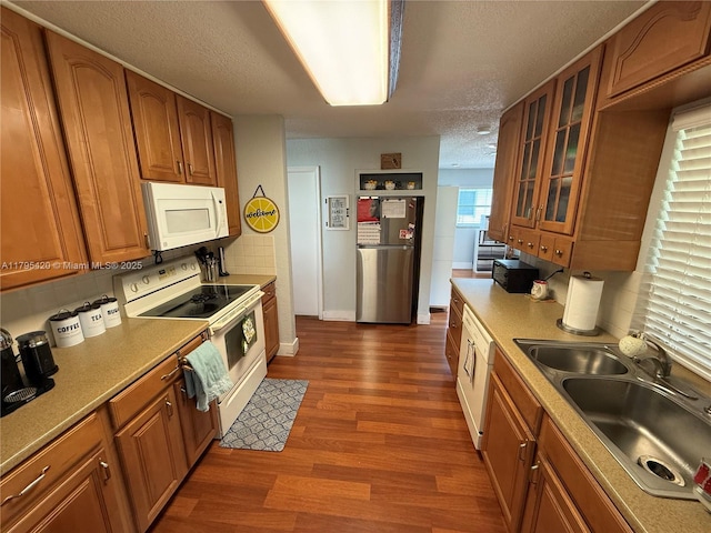 1250 NW 85th Ave, Plantation, FL 33322 - kitchen featuring white appliances, a sink, brown cabinets, dark wood-style floors, and a textured ceiling