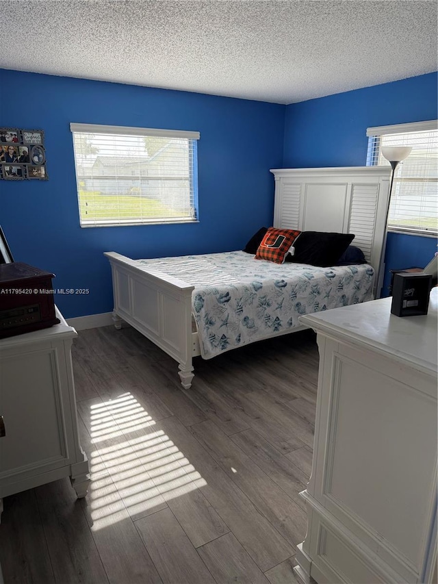 1250 NW 85th Ave, Plantation, FL 33322 - bedroom featuring wood finished floors, multiple windows, and a textured ceiling