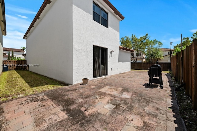 22780 SW 92nd Ct, Cutler Bay, FL 33190 - rear view of property featuring stucco siding, a patio area, and a fenced backyard