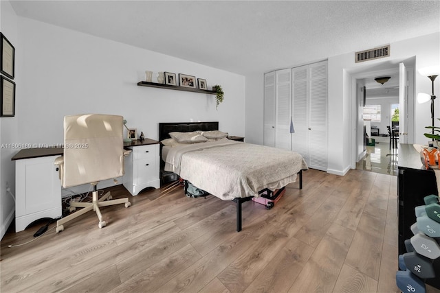 bedroom with light wood-style flooring and a closet