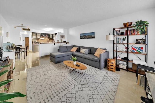 living room featuring bar and light tile patterned flooring