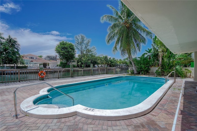 view of pool with a fenced backyard