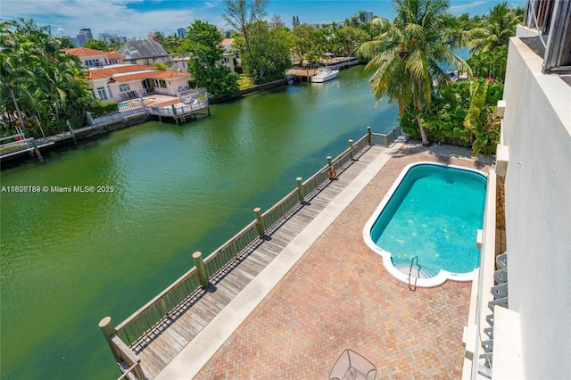 view of swimming pool with a water view