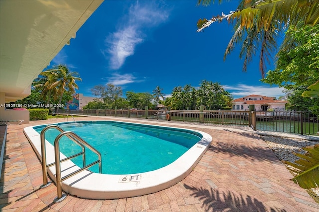 view of pool with a fenced backyard and a patio area