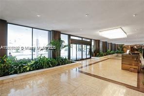 5555 Collins Ave Unit 14U, Miami Beach, FL 33140 - building lobby featuring a wall of windows