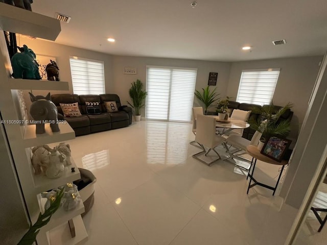 living area featuring tile patterned flooring and recessed lighting