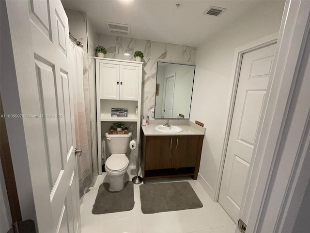 full bathroom featuring toilet, vanity, tile patterned floors, and a shower with shower curtain