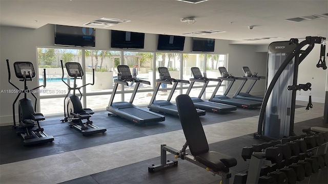 workout area with plenty of natural light and baseboards
