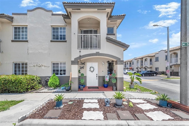 11429 NW 93rd Ct Unit 1, Hialeah Gardens, FL 33018 - view of front facade with stucco siding, a balcony, and a tile roof