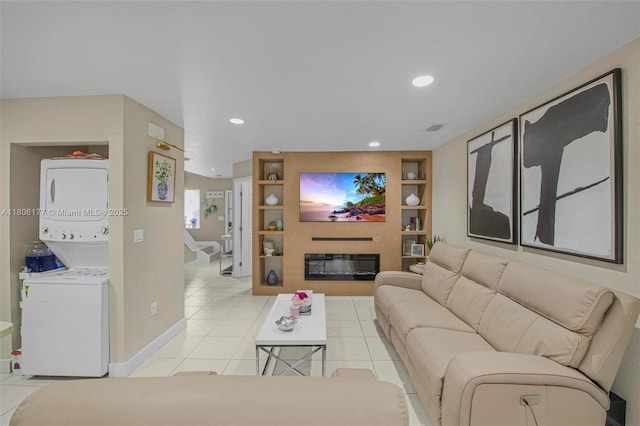 11429 NW 93rd Ct Unit 1, Hialeah Gardens, FL 33018 - living room with stacked washing machine and dryer, built in shelves, light tile patterned floors, a glass covered fireplace, and recessed lighting
