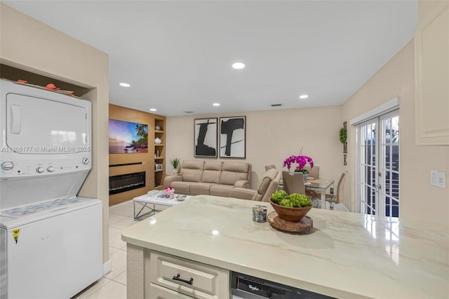 11429 NW 93rd Ct Unit 1, Hialeah Gardens, FL 33018 - kitchen featuring stacked washer and clothes dryer, french doors, light tile patterned floors, built in shelves, and light stone counters