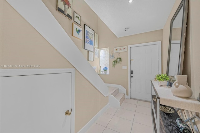 11429 NW 93rd Ct Unit 1, Hialeah Gardens, FL 33018 - foyer featuring stairway, light tile patterned flooring, and baseboards