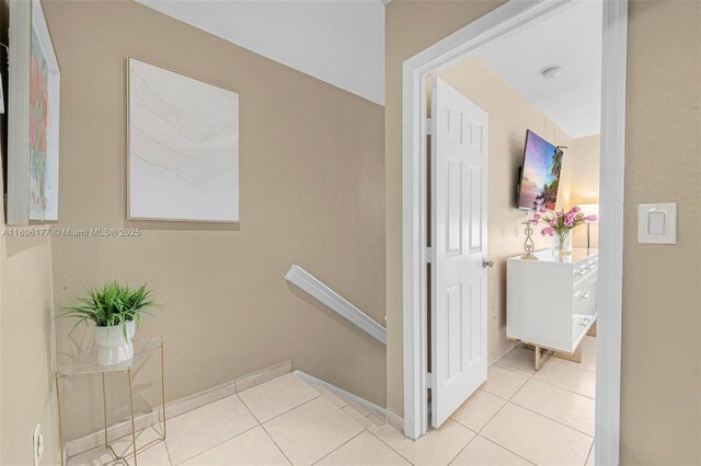 11429 NW 93rd Ct Unit 1, Hialeah Gardens, FL 33018 - corridor featuring light tile patterned floors and baseboards