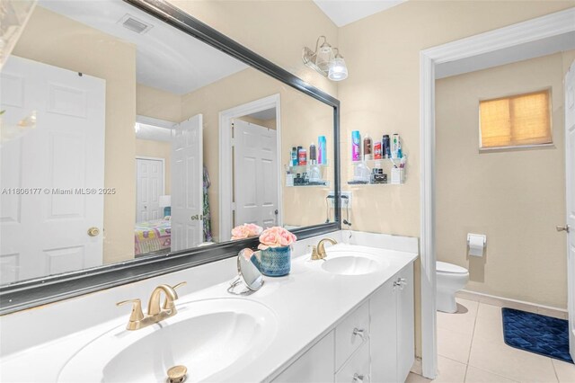 11429 NW 93rd Ct Unit 1, Hialeah Gardens, FL 33018 - full bathroom featuring double vanity, tile patterned flooring, toilet, and baseboards