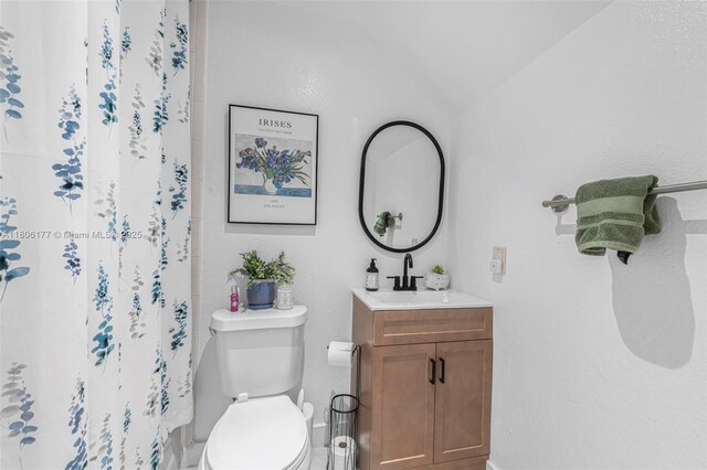 11429 NW 93rd Ct Unit 1, Hialeah Gardens, FL 33018 - full bathroom featuring vanity, toilet, lofted ceiling, a shower with shower curtain, and baseboards