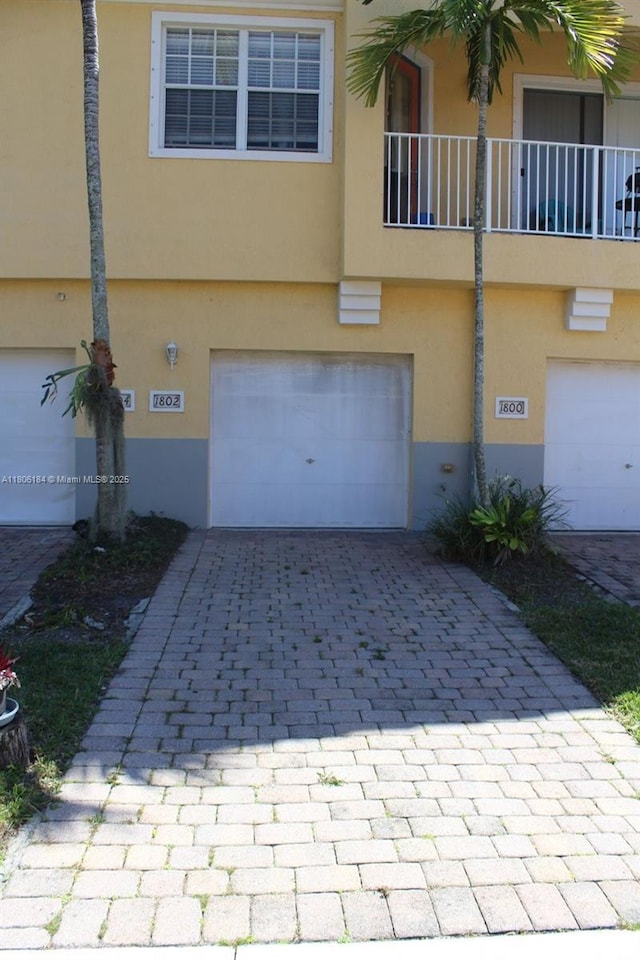 garage featuring decorative driveway