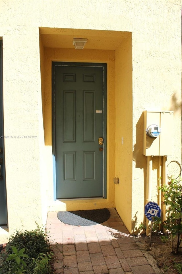entrance to property with stucco siding