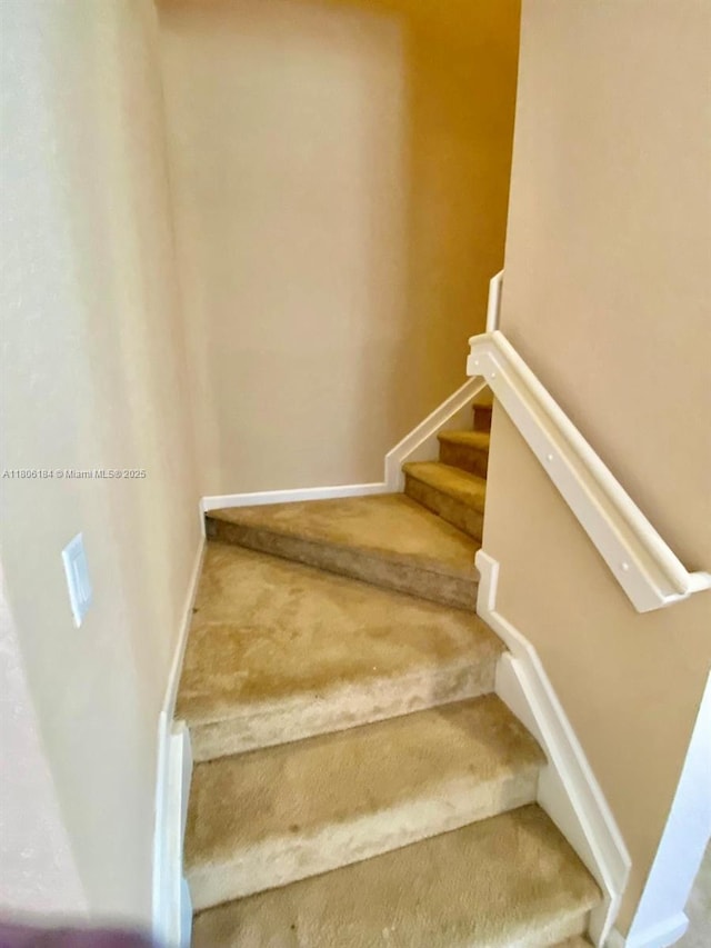 staircase with carpet flooring and baseboards