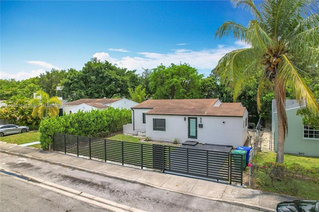 280 NW 45th St, Miami, FL 33127 - view of front facade with stucco siding, entry steps, and roof with shingles