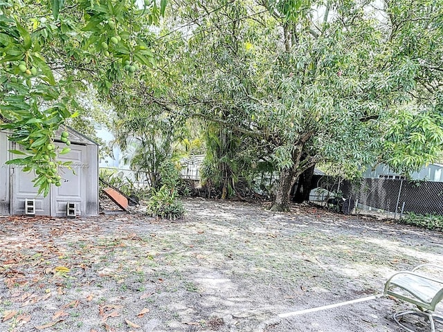 280 NW 45th St, Miami, FL 33127 - view of yard featuring fence, a storage shed, and an outbuilding