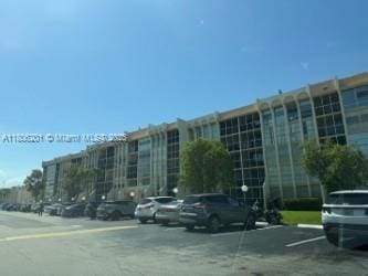 801 Three Islands Blvd Unit 112, Hallandale Beach, FL 33009 - view of building exterior featuring uncovered parking