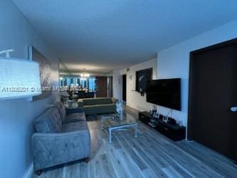 801 Three Islands Blvd Unit 112, Hallandale Beach, FL 33009 - living room with wood finished floors and a chandelier